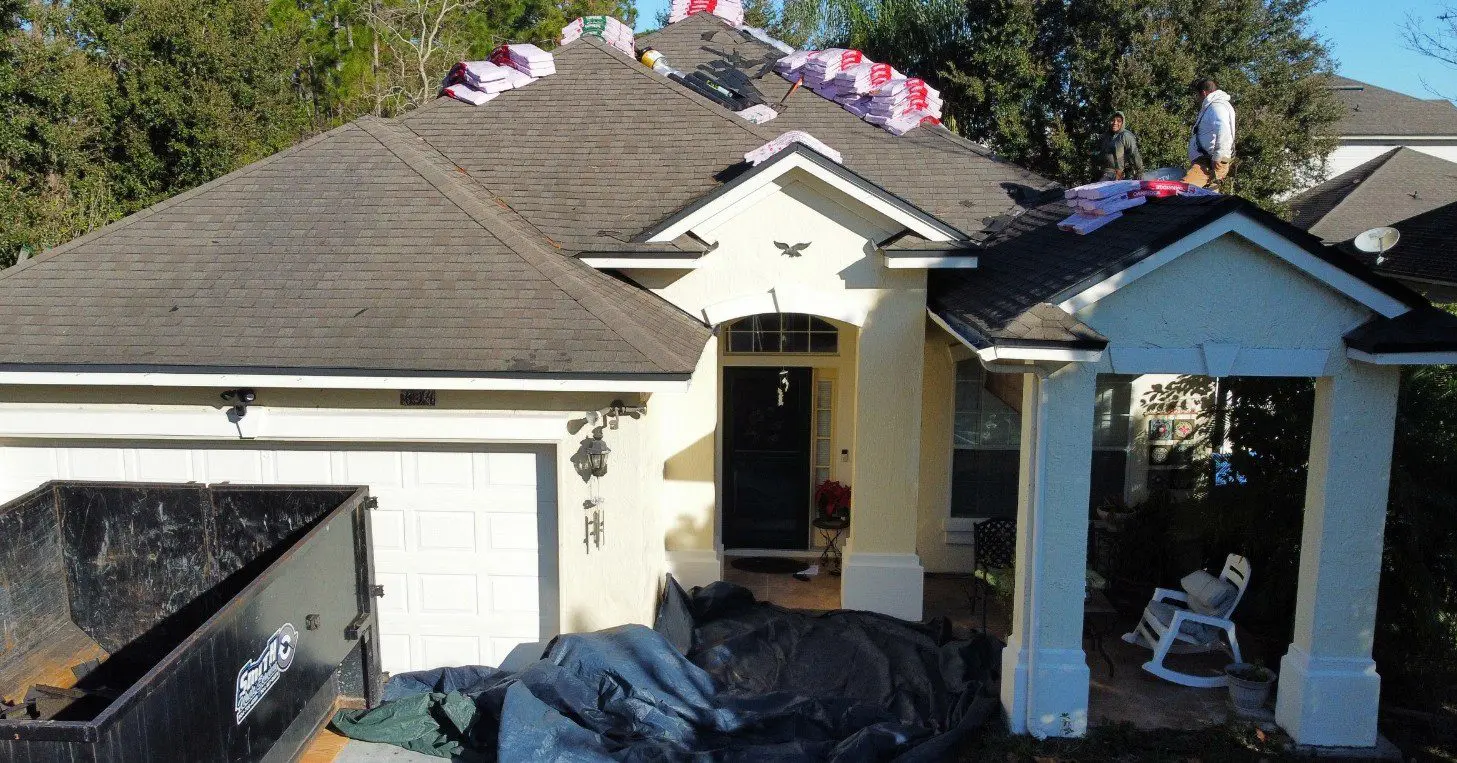 House roof under renovation with construction materials.