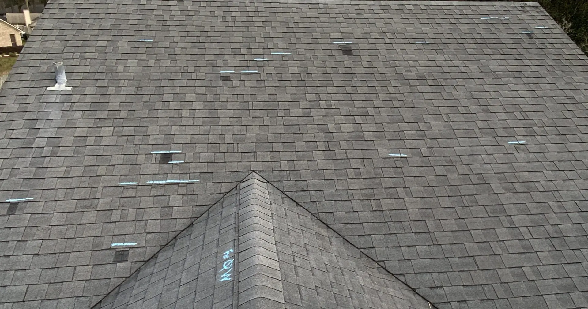 Gray shingled roof with visible wear marks.