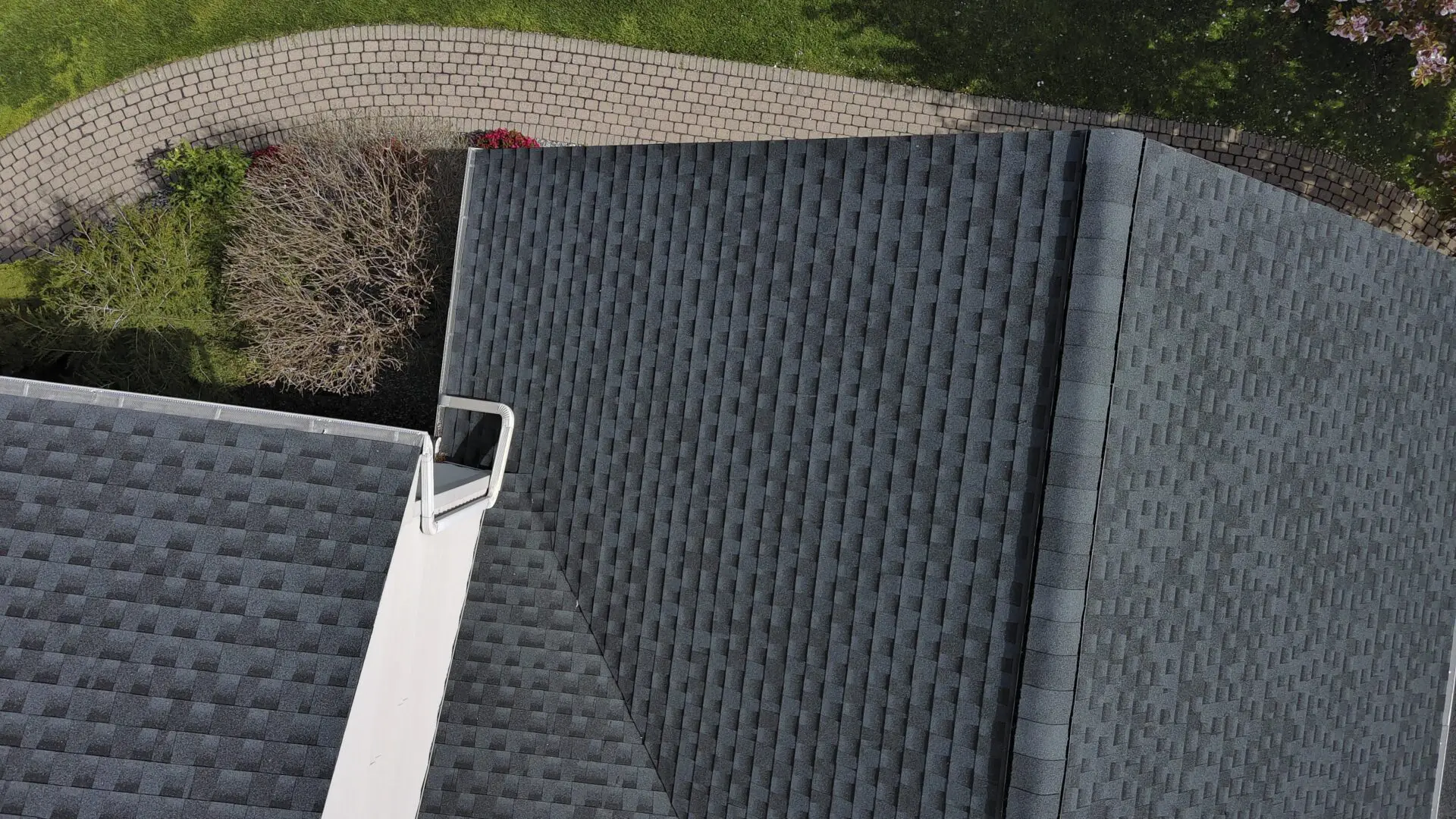 Aerial view of house roof and garden.